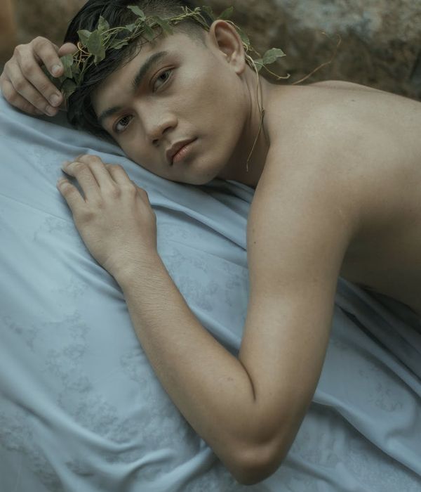 Man meditating peacefully in a calm, modern environment with soft lighting.